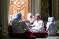 Happy lovely muslim young girls in traditional clothing with male muslim teacher inside the mosque. Nong Chok, Bangkok, Thailand